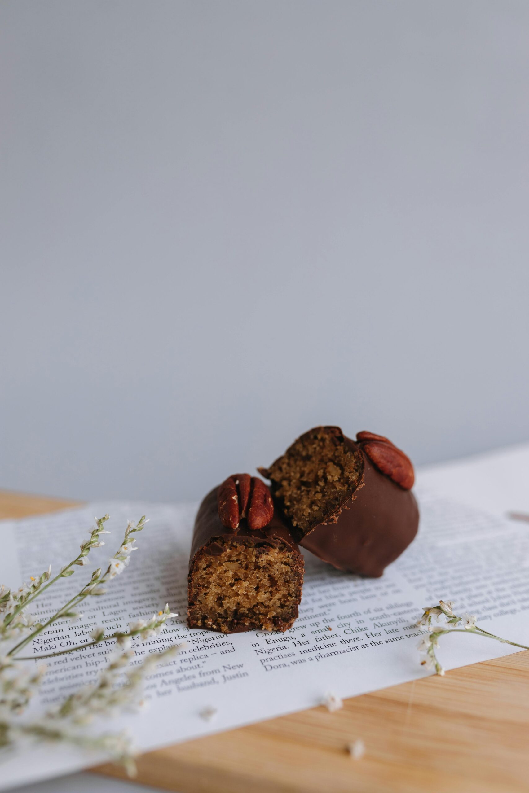Delicious chocolate covered nut bar displayed on paper with natural decor.